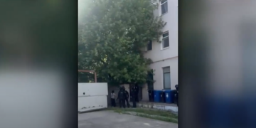 Femeie preluată de ambulanță cu ajutorul mascaților, după ce accesul în bloc a fost blocat cu lacăt